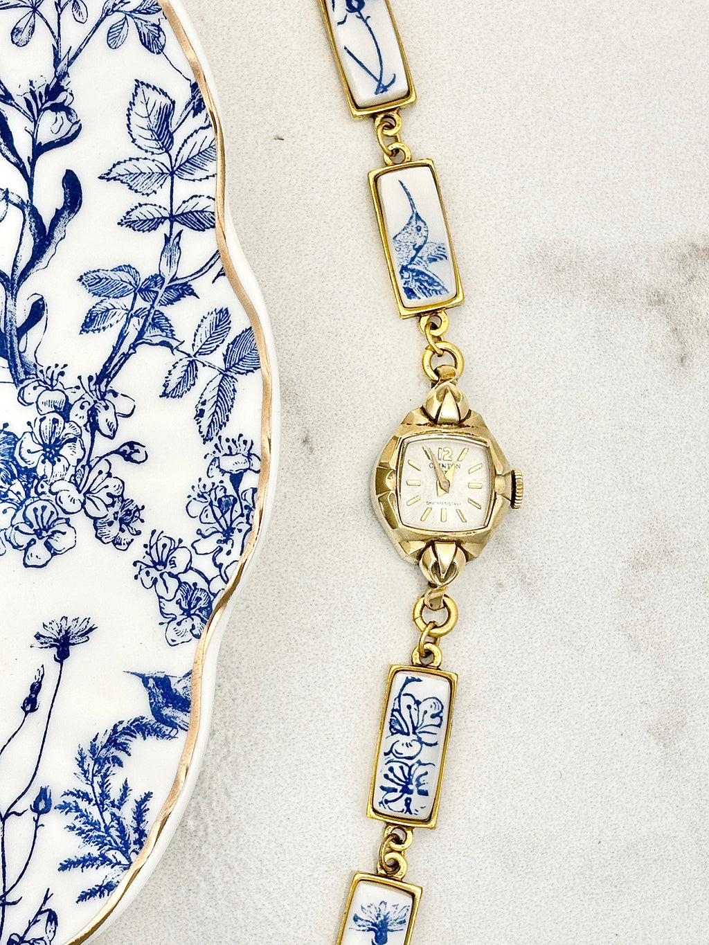 Antique Clinton manual watch with blue hummingbirds